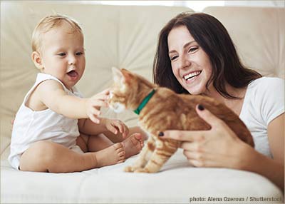 Mother Introducing Cat to Baby